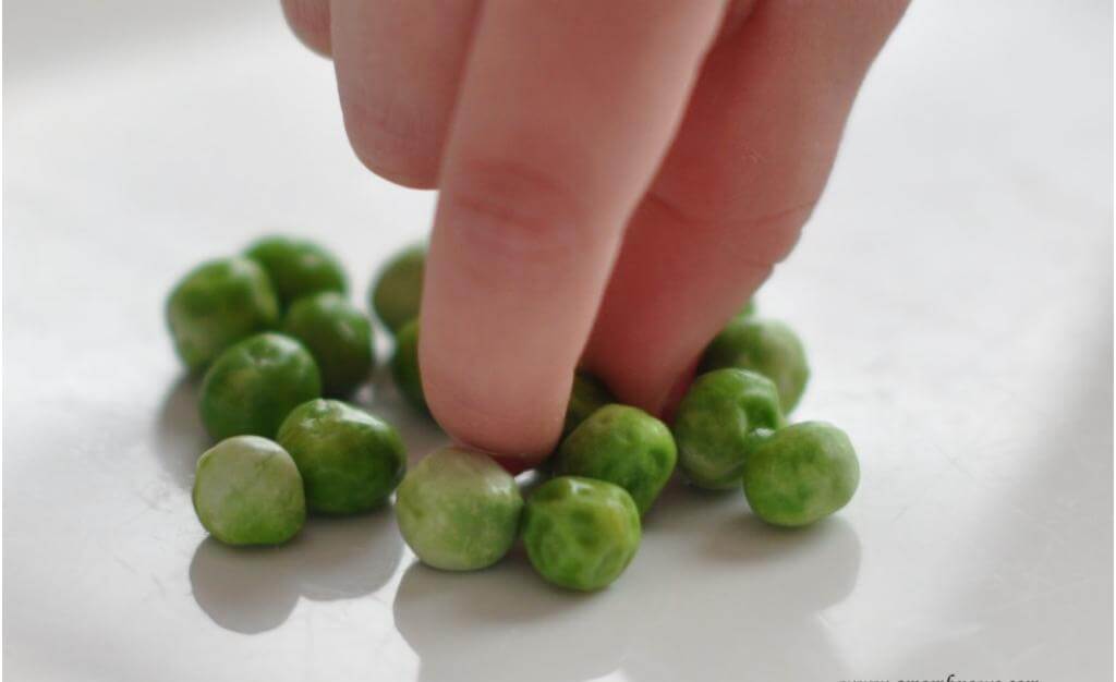 Picky eater touching peas